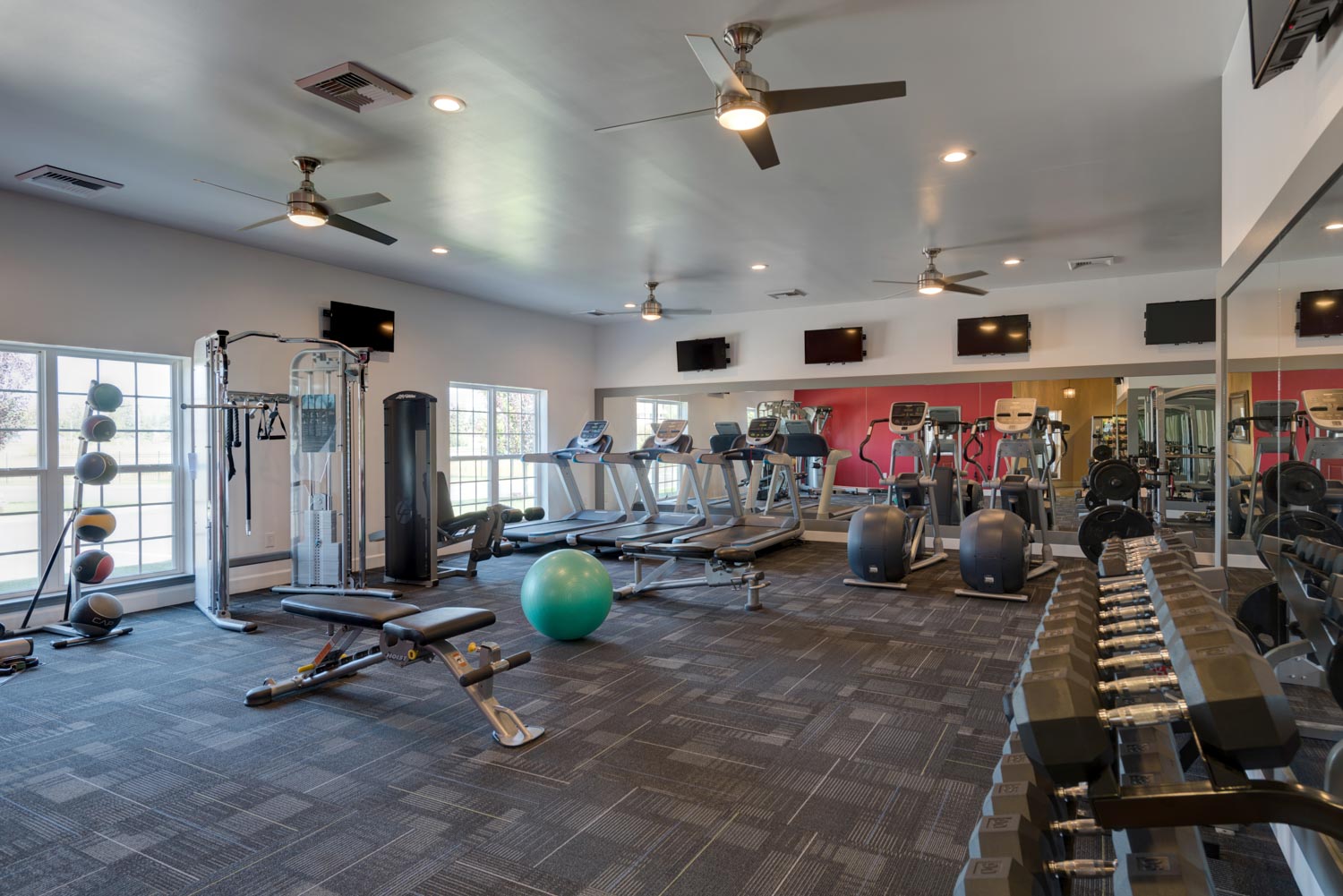 Modern gym with various equipment.